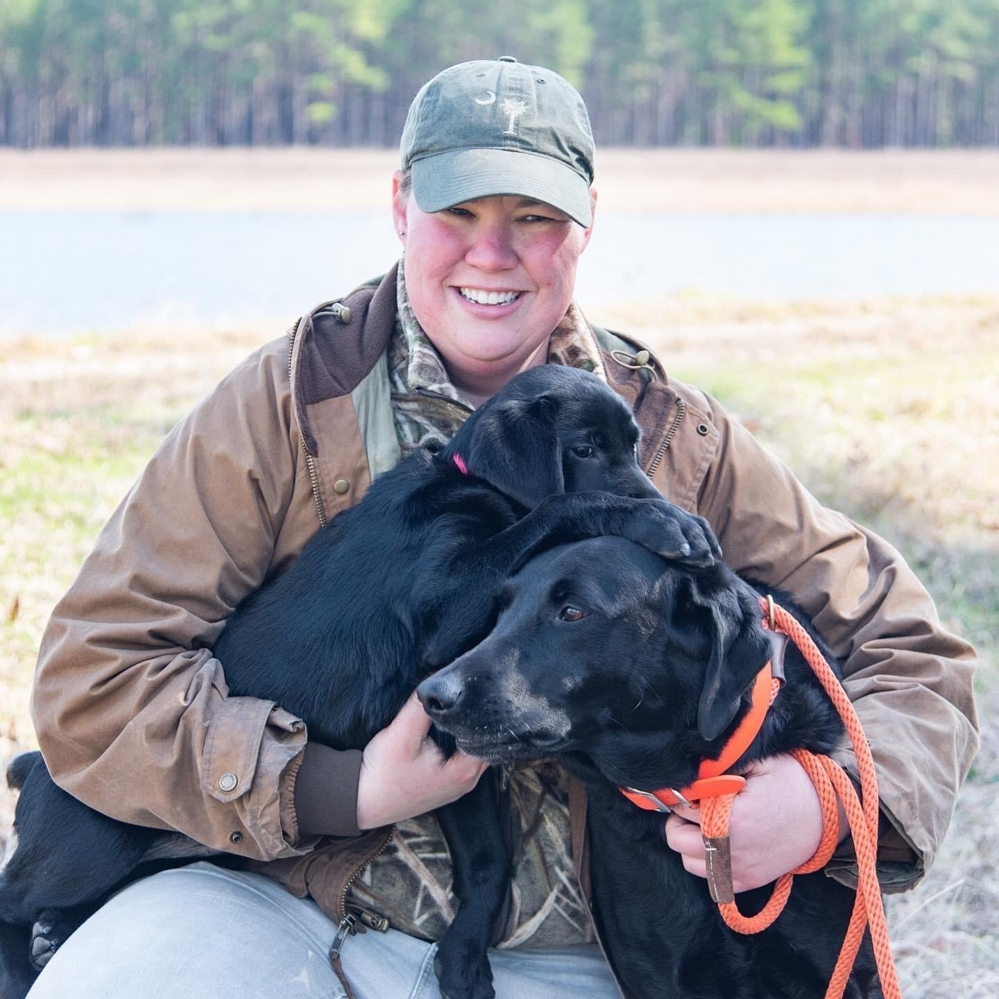 Molly Kneece poses with still-puppy Kate and Willie for a South Carolina Wildlife magazine photo shoot in early 2019. [SCDNR photo by Taylor Main]
