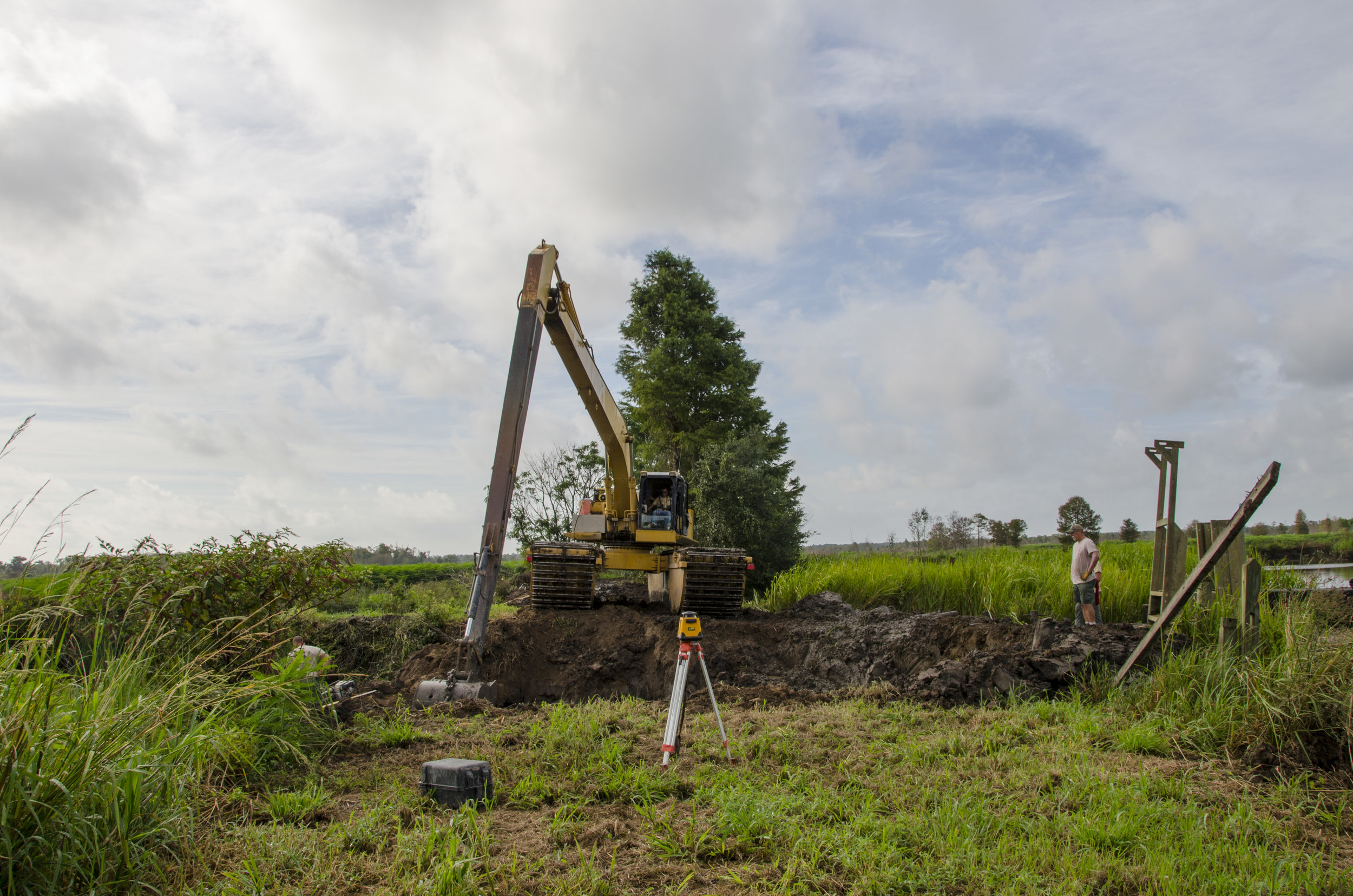 Electronic levels and surveying tools help the crew make an accurate dig.