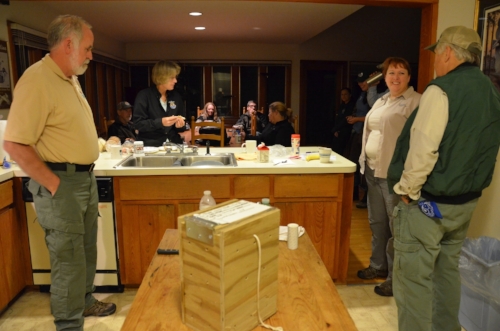 SCDNR biologists Derrell Shipes, Caroline Causey and Dean Harrigal talk with members of an RCW translocation team made up of staff and volunteers from several state and federal agencies at Donnelley lodge. In the foreground is an example of the box …