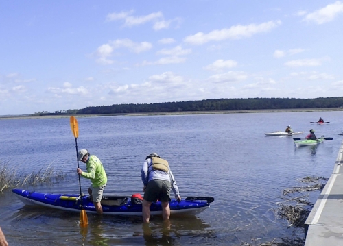 Club member Bill Dickinson demonsttrates the right way to enter and exit a kayak.photo by Nancy Stills, Sun City Hilton Head Kayak Club