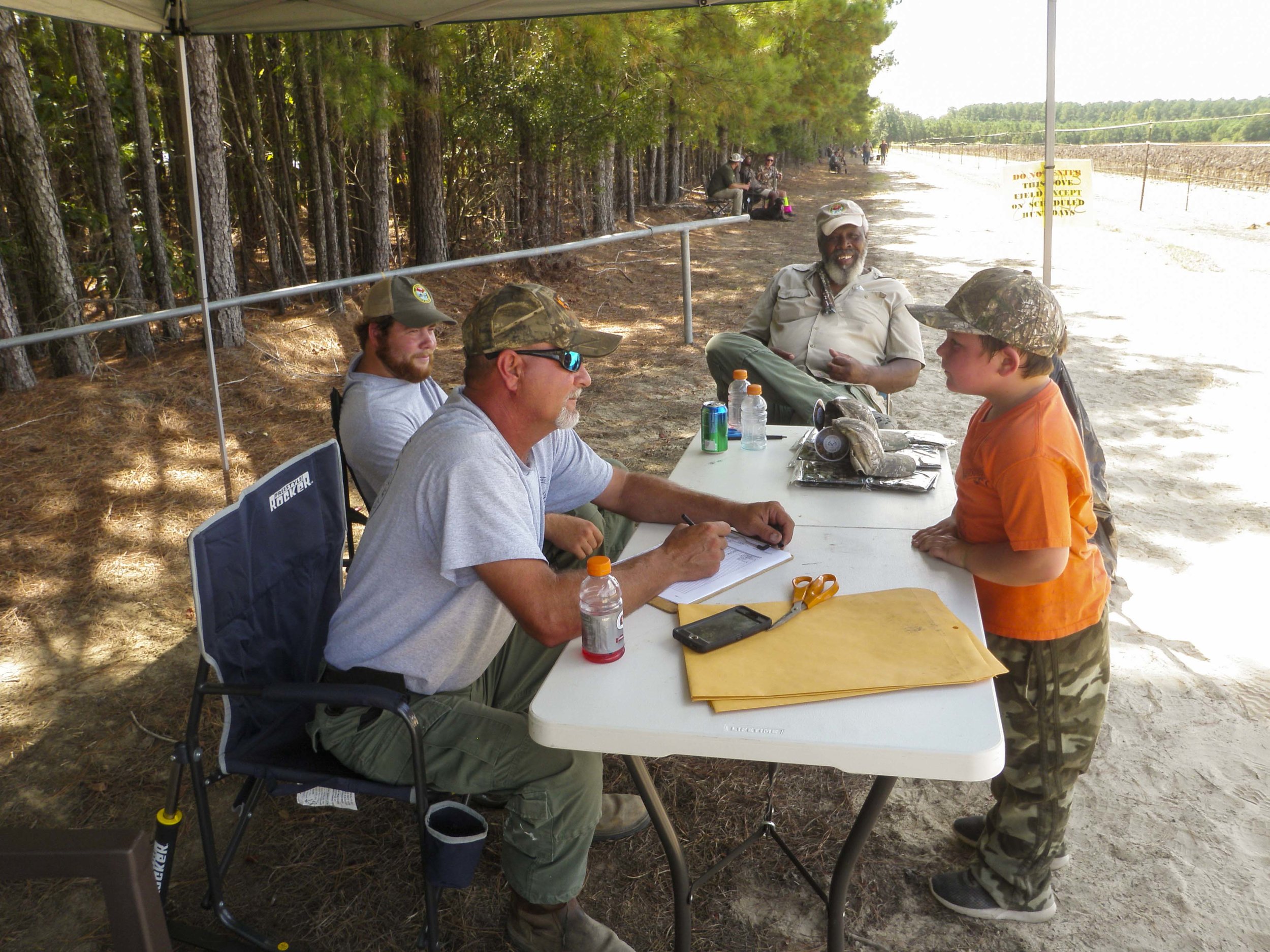 SCDNR wildlife technicians collect data from a young hunter at Pee Dee Station dove field.
