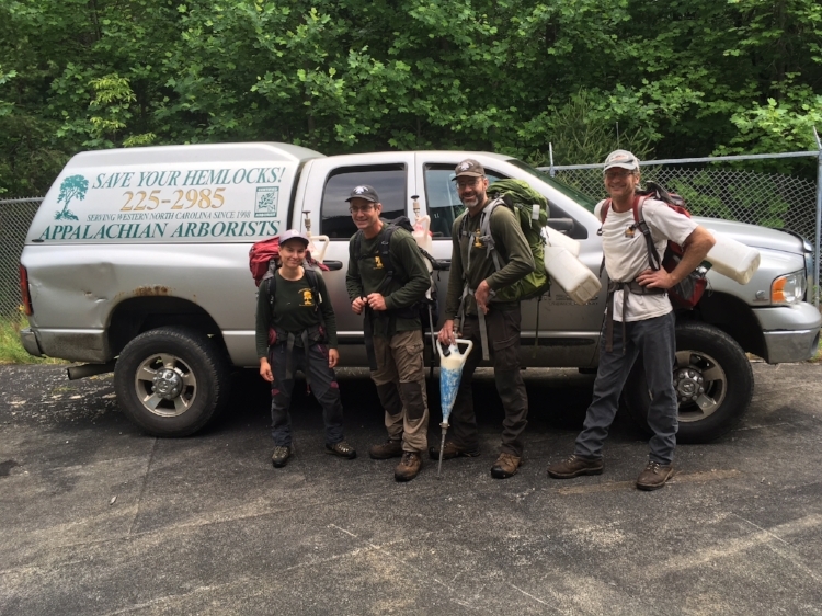 In the parking lot at Bad Creek, the "Hemlock Rescue" crew prepares to hike in with the gear and supplies they'll need for a long day of treating hemlocks along the Whitewater River against the invasive hemlock woolly adelgid.