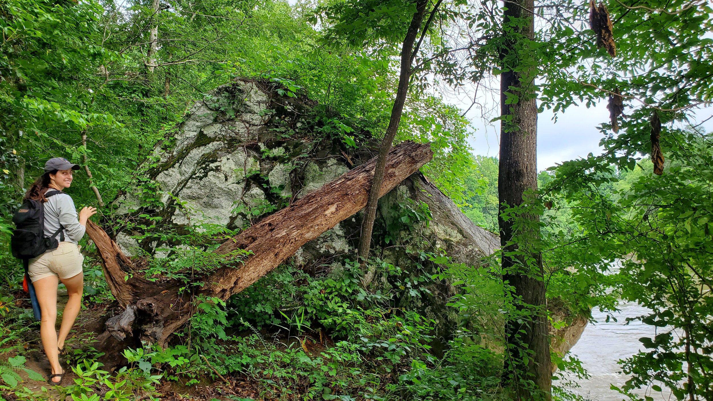 Fishing partner Amy stands next to a striking rock outcrop along the trail.