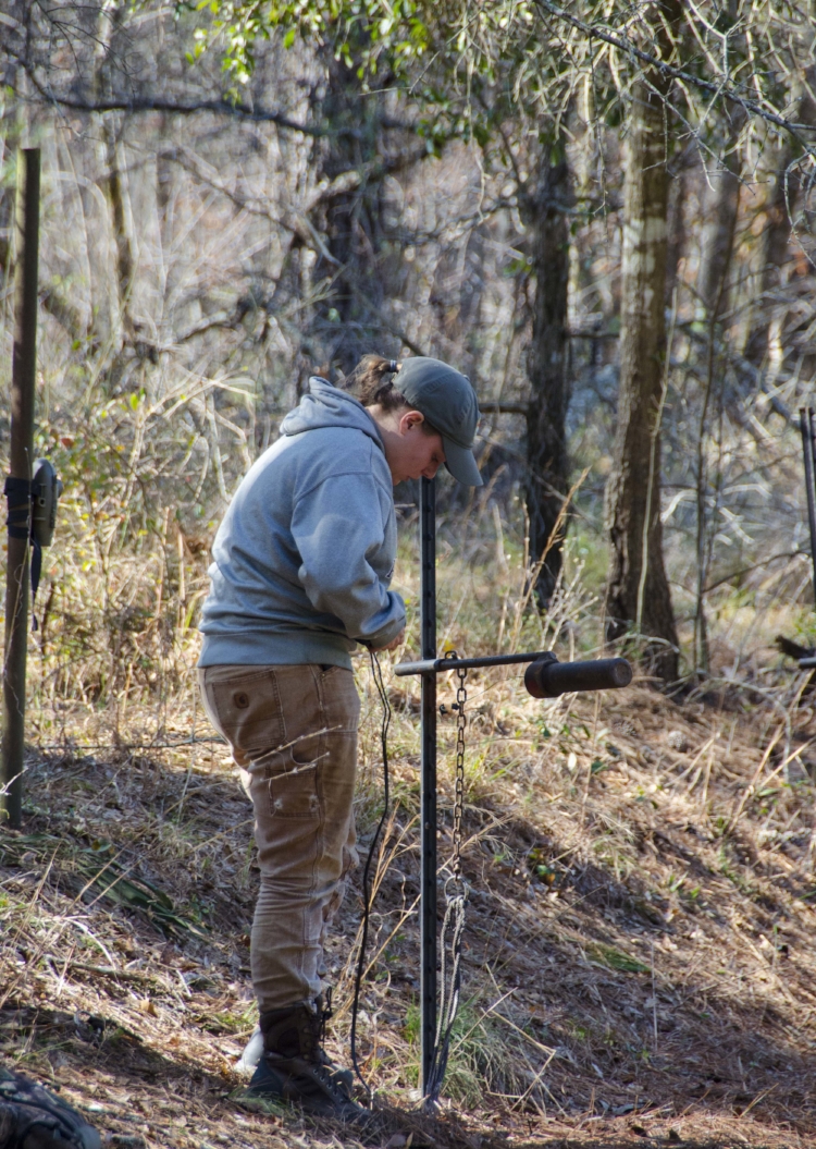 Alaina Gerrits makes an adjustment to a rocket net setup. (SCDNR photo by David Lucas)