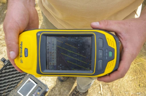 (Above) Mota demonstrates the use of the VHF telemetry equipment, and (below), Cooley shows off the GPS equipment that is used to conduct the transect surveys during which the team searches properties for tortoise burrows.