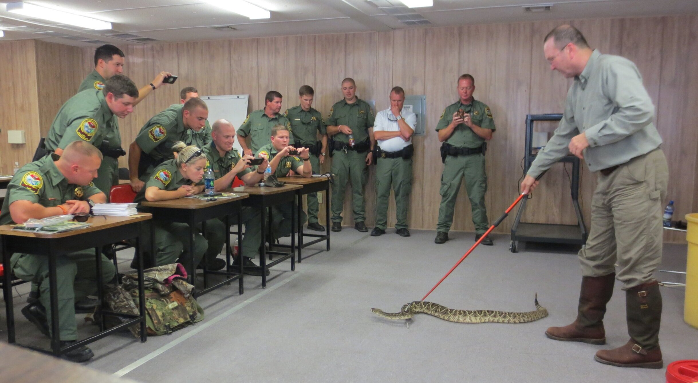 Riverbanks Zoo Curator of Herpetology Scott Pfaff demonstrates safe handling of a diamondback rattlesnake for a training group of SCDNR Officers. During his four-decade career with Riverbanks, Pfaff has worked with SCDNR on many joint research endea…